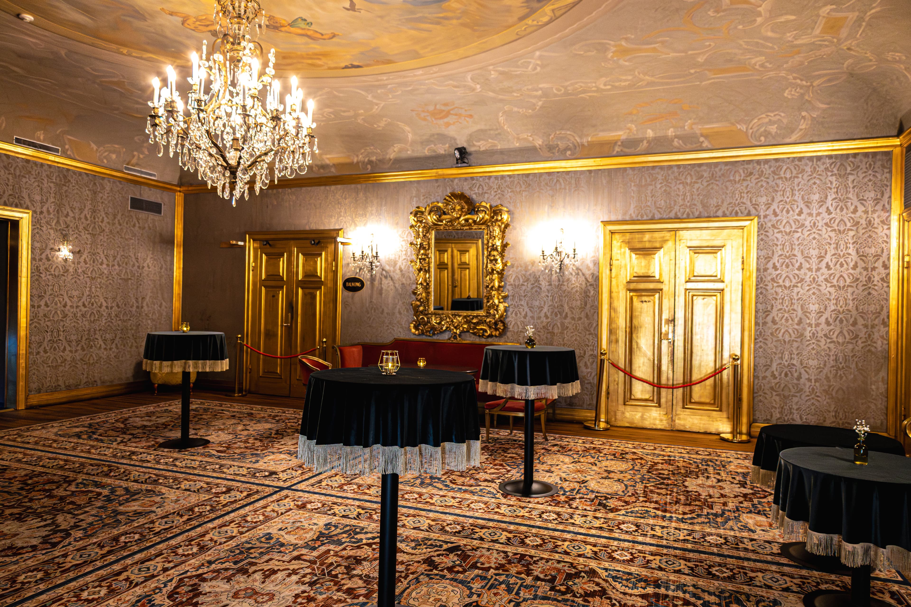 The Gold Foyer set for a reception – crystal chandelier, ceiling murals and cocktail tables