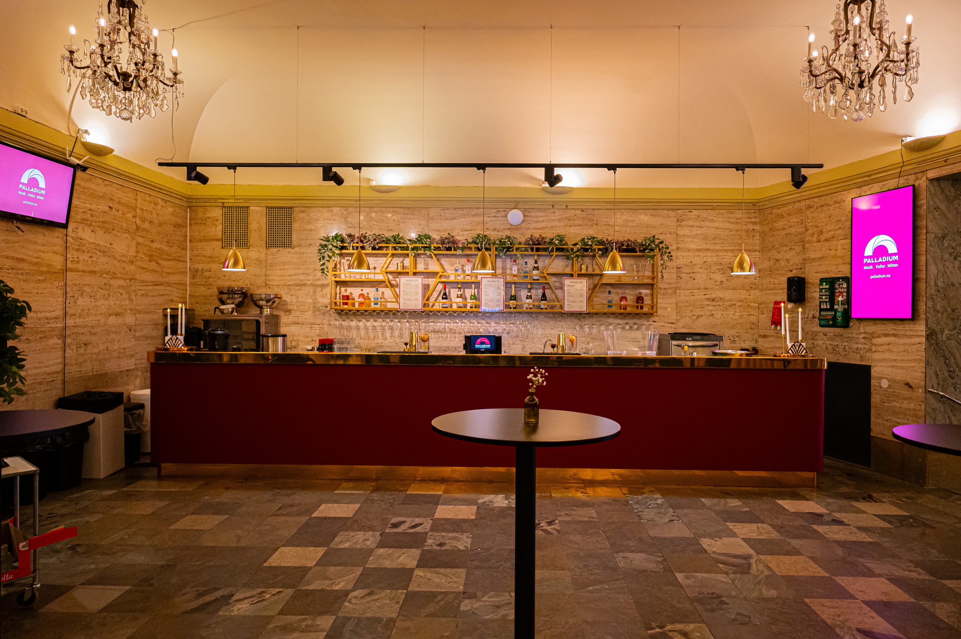 The Marble Foyer's bar with brass details, marble walls and checkered stone floor