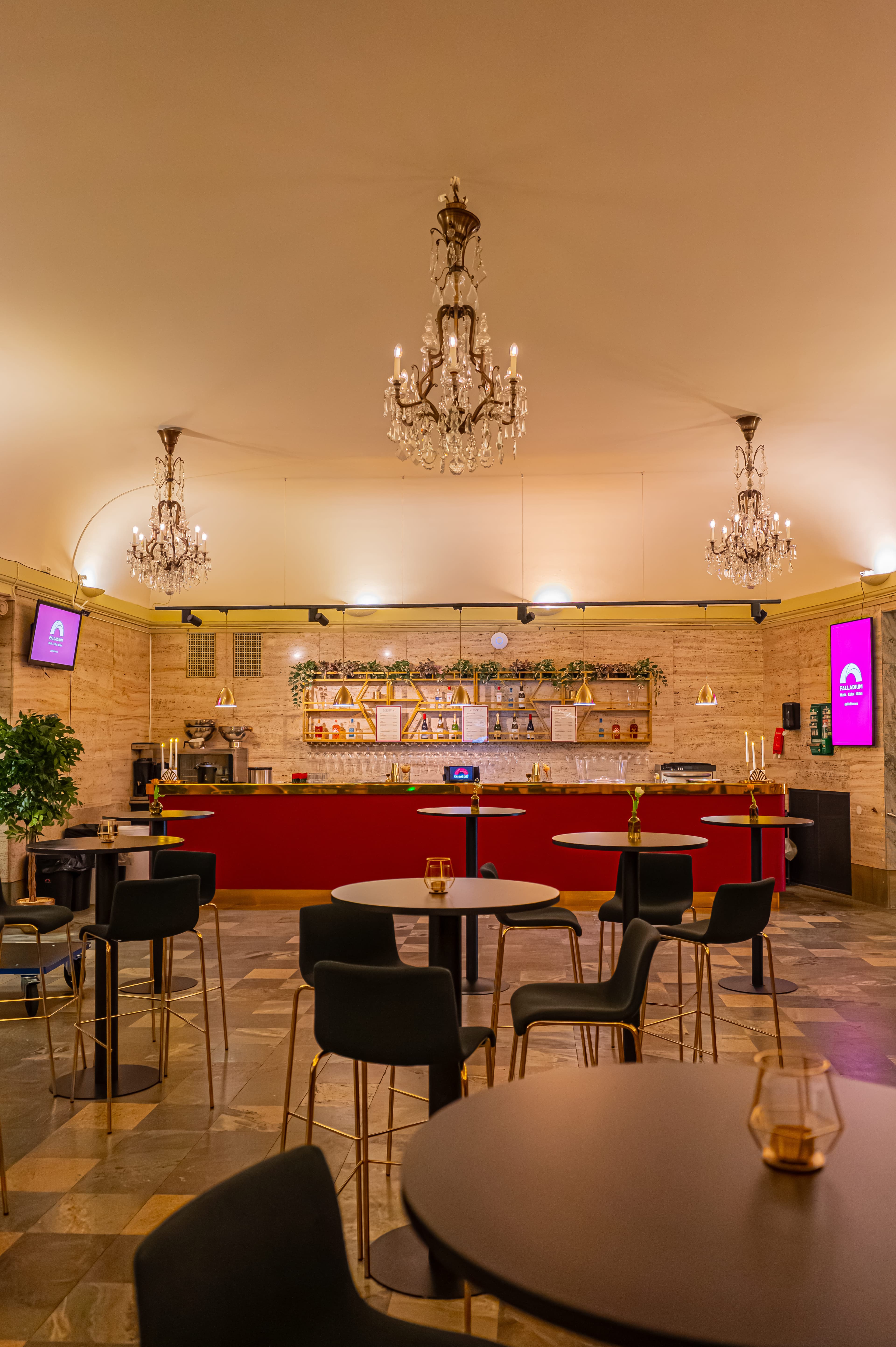 Bar seating in The Marble Foyer – high tables and chairs beneath three crystal chandeliers